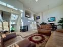 Spacious living room featuring a modern fireplace, staircase, and natural light at 1469 S Ulster St, Denver, CO 80231