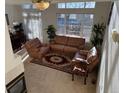 Sunlit living room with comfortable seating, a fireplace, and an open layout at 1469 S Ulster St, Denver, CO 80231