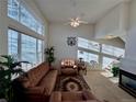 Bright living room featuring a large window, vaulted ceiling and a cozy fireplace at 1469 S Ulster St, Denver, CO 80231