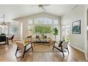 Bright and airy living room featuring vaulted ceilings, large windows, and stylish contemporary furnishings at 3930 Miller St, Wheat Ridge, CO 80033