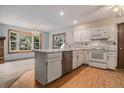 Bright kitchen features updated appliances, a center island, and a view to the backyard at 523 E Long Ct, Littleton, CO 80122