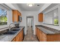 Eat-in kitchen featuring granite countertops, a tiled floor, and stainless steel appliances at 440 Balsam St, Lakewood, CO 80226