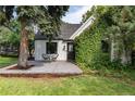 Updated craftsman home with white siding and ivy-covered brick at 9393 W 14Th Ave, Lakewood, CO 80215