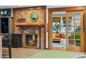 Cozy living room with a brick fireplace, wood trim, and an open doorway to another seating area at 1051 Independence St, Lakewood, CO 80215