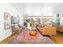 Spacious living room with a large patterned rug, a leather couch, and bright natural light at 800 Washington St # 302, Denver, CO 80203