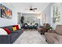 Bright living room with neutral colors, large windows, and comfortable seating, perfect for relaxing and entertaining at 4797 Flower St, Wheat Ridge, CO 80033
