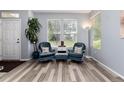 Comfortable living room with wood floors, large windows, and stylish furnishings at 4797 Flower St, Wheat Ridge, CO 80033