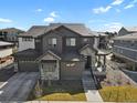 A wide shot showcasing the home's exterior, including a three-car garage and well-manicured lawn at 3422 W 155Th Ave, Broomfield, CO 80023