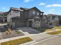 Two-story home showcasing a three-car garage, stone accents, and a well-kept lawn at 3422 W 155Th Ave, Broomfield, CO 80023