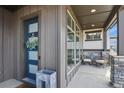 Inviting front porch with stone accents and outdoor seating, creating a welcoming entrance at 3422 W 155Th Ave, Broomfield, CO 80023