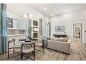 Well-lit open-concept living and dining area featuring wood flooring and contemporary decor with bright light at 485 Interlocken Blvd # 106, Broomfield, CO 80021