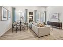 Cozy living area with modern furniture, light wood flooring, and stylish decor under bright light at 485 Interlocken Blvd # 106, Broomfield, CO 80021