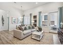 Bright living room with modern decor, wood floors, a comfortable sofa, and natural light from the window at 485 Interlocken Blvd # 106, Broomfield, CO 80021