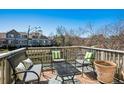 Relaxing deck overlooking a tranquil pond, complete with stylish outdoor furniture and decorative pillows at 6024 W Colorado Ln, Lakewood, CO 80232