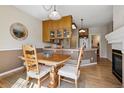 Cozy dining area with wood table and chairs, seamlessly connected to the kitchen and living spaces at 6024 W Colorado Ln, Lakewood, CO 80232