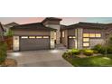 A lovely home exterior with attached garages, beautiful stone accents, and a well-maintained yard with tasteful landscaping at 11193 Mission Walk St, Parker, CO 80134