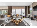 Bright living room with modern decor, large windows, fireplace, and stylish furnishings at 11193 Mission Walk St, Parker, CO 80134