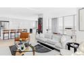 Bright living room with large windows and modern furniture next to kitchen at 3100 E Cherry Creek South Dr # 1201, Denver, CO 80209