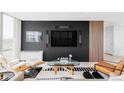 Modern living room with large TV and wood paneling at 3100 E Cherry Creek South Dr # 1201, Denver, CO 80209