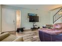 Cozy living room with wood floors, TV, and stairway at 3354 S Flower St # 14, Lakewood, CO 80227
