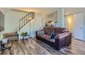Inviting living room featuring wood floors, stairs, and a pass-through to the kitchen at 3354 S Flower St # 14, Lakewood, CO 80227