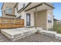 Stylish front porch with a modern design, concrete steps, and a sleek black front door at 9715 Taylor River Cir, Littleton, CO 80125