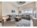 Bright living room featuring high ceilings, large windows, and comfortable seating area with stylish decor at 9715 Taylor River Cir, Littleton, CO 80125