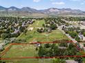 Sprawling aerial view of the property showing a large plot of land with mountain views in the distance at 12196 W Belleview Dr, Littleton, CO 80127