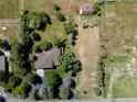 Aerial view of property showing the house, barn, driveway, and surrounding yard at 12196 W Belleview Dr, Littleton, CO 80127