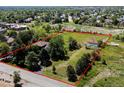 Large lot featuring lush landscape outlined in red showcasing a home and surrounding trees at 12196 W Belleview Dr, Littleton, CO 80127