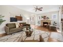 Inviting living room featuring a cozy fireplace, hardwood floors, and stylish decor at 2318 S Lincoln St, Denver, CO 80210