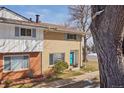 A well-maintained townhouse with a bright turquoise door and landscaped front yard at 12531 W Alameda Dr, Lakewood, CO 80228