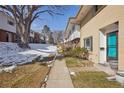 Sidewalk view of inviting townhouses with manicured lawns and mature trees at 12531 W Alameda Dr, Lakewood, CO 80228