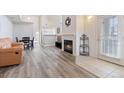 Open-concept living room boasts hardwood flooring, a fireplace, and seamless access to the kitchen and dining area at 18661 E Water Dr # F, Aurora, CO 80013