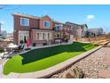 Spacious backyard with manicured lawn, outdoor dining set, elevated deck, and play set ideal for recreation and relaxation at 3745 Spanish Oaks Trl, Castle Rock, CO 80108
