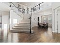 Spacious entryway featuring hardwood floors, stairs, and an open layout at 3745 Spanish Oaks Trl, Castle Rock, CO 80108