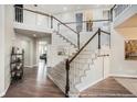 Grand staircase with white railing and carpeted steps leading to the second floor at 3745 Spanish Oaks Trl, Castle Rock, CO 80108