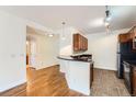 Kitchen with breakfast bar, dark countertops, tile floor and modern lighting at 9079 E Panorama Cir # 309, Englewood, CO 80112