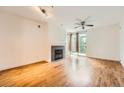 Bright living room with hardwood floors, fireplace, ceiling fan, and a balcony at 9079 E Panorama Cir # 309, Englewood, CO 80112