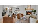 Cozy living area with brick fireplace, stylish seating, and an open floor plan at 6620 S Foresthill St, Littleton, CO 80120