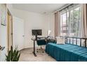 Cozy bedroom furnished with a desk, modern monitor setup, and comfortable decor at 8711 E Hampden Ave # 26, Denver, CO 80231