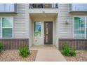 Charming home exterior showcasing a front door with decorative glass panel and manicured landscaping at 8711 E Hampden Ave # 26, Denver, CO 80231