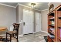 Inviting entryway with wood-look flooring, neutral paint, and practical built-ins, creating a welcoming ambiance at 12183 W Cross Dr # 202, Littleton, CO 80127