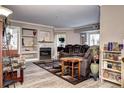 Spacious living room featuring a fireplace with stone accents, built-in shelves, and comfortable seating at 12183 W Cross Dr # 202, Littleton, CO 80127