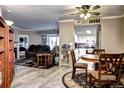 Open-concept living room flows into a cozy dining area and features modern finishes and natural light at 12183 W Cross Dr # 202, Littleton, CO 80127