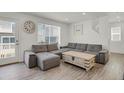 Comfortable living room with plush sectional sofa, stylish decor, and a large window at 18233 E 51St Ave, Denver, CO 80249