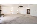 Bright and spacious living room featuring neutral walls, carpet flooring, and a vaulted ceiling at 8195 Field Ct, Arvada, CO 80005