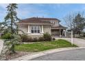 Elegant home with a well-manicured lawn, stylish pillars, and a neutral color palette at 6556 S Versailles Ct, Aurora, CO 80016