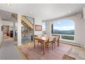 Bright dining room featuring a large picture window with mountain views and an adjacent staircase at 606 Sugarloaf Mountain Rd, Boulder, CO 80302
