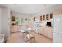 Cozy kitchen features tile countertops, a glass dining table, tile floors, and ample cabinet space at 606 Sugarloaf Mountain Rd, Boulder, CO 80302